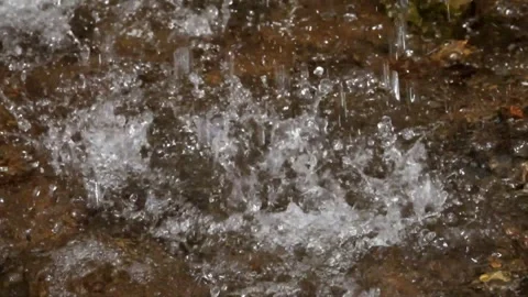 The splash of a small and natural waterfall Stock Footage 297805988