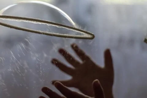 Splash soap balloon in hands Stock Photos