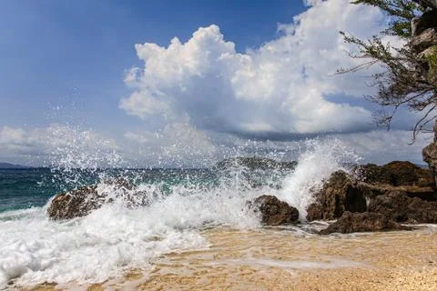 Splash water on beach Stock Photos