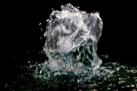 Splash of water on black background Stock Photos