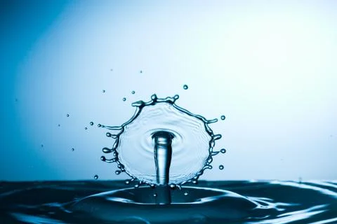 Splash of water on blue background Stock Photos