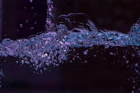 Splash of water with bubbles and dark background Stock-Fotos