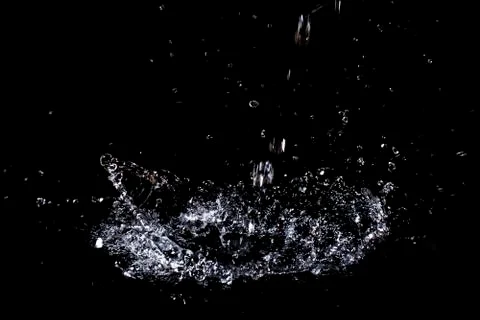 Splash of water. Isolate on black background Stock Photos