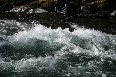 Splash of water in mountain river Stock Photos