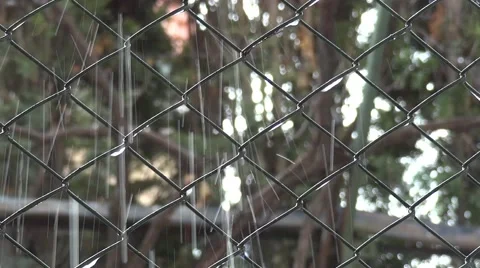 Splash water running down a twisted wire fence Stockbeeldmateriaal 58287964