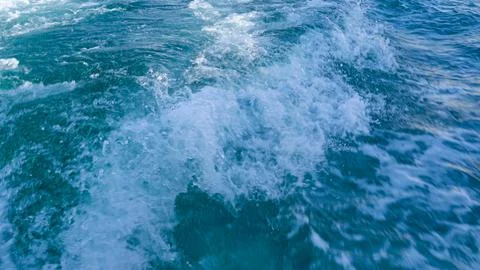 Splash water wave with foam made from the boat's motor in ocean Stock Photos