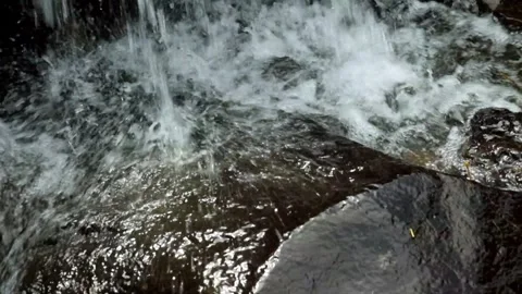 Splash of waterfall falling on river rocks Stock-Footage 320104925