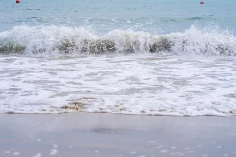 Splash wave on the surface on the beach Stock Photos