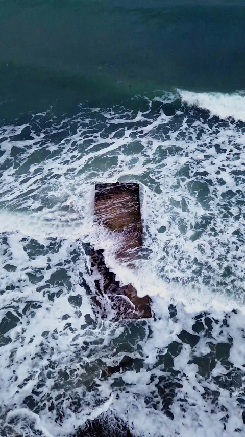 The splash of waves on a breakwater in a storm on a cloudy winter day. Stock Footage 327372174