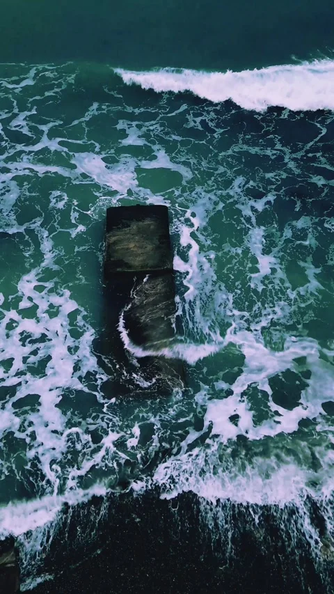The splash of waves on a breakwater in a storm on a cloudy winter day. Stock Footage 327372189