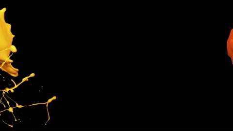 Splash of yellow and orange paint liquid in slow motion isolated on black (4K) Video stock 137112231