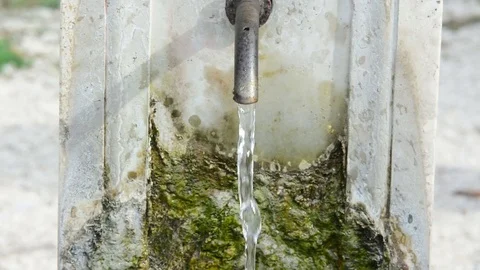 Splashed water drops in a stone standpipe, in a park of Rome, Italy Stock Footage 80427868