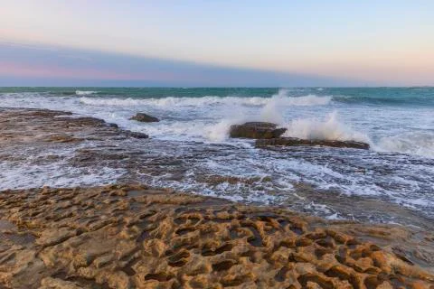 Splashes from the beating wave on the rocks Stock Photos
