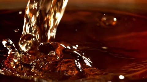 Splashes of black tea. Filmed on a high-speed camera at 1000 fps. Stock Footage 308309745