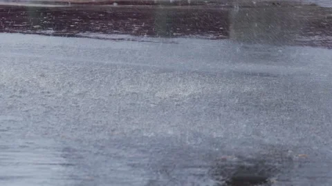 Splashes from car wheels on the road while driving through puddles in the city Stock Footage 291676373