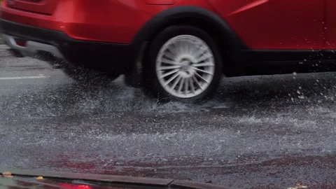 Splashes from car wheels on the road while driving through puddles in the city Stock-Footage 291676997