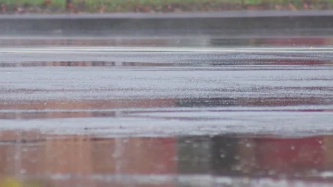 Splashes from car wheels on the road while driving through puddles in the city Vídeo Stock 300864357