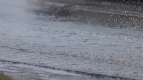 Splashes from car wheels on the road while driving through puddles in the city Stock Footage 300864516