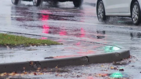 Splashes from car wheels on the road while driving through puddles in the city Stock-Footage 309917437