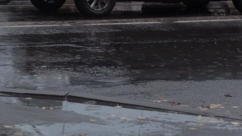 Splashes from car wheels on the road while driving through puddles in the city Stock Footage 309917846