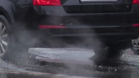 Splashes from car wheels on the road while driving through puddles in the city Stock Footage 310938297