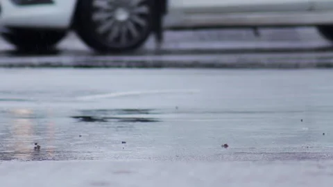 Splashes from car wheels on the road while driving through puddles in the city Stock Footage 311645481