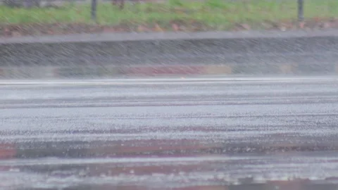 Splashes from car wheels on the road while driving through puddles in the city Stock Footage 311645700