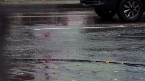 Splashes from car wheels on the road while driving through puddles in the city Stockbeeldmateriaal 314426045