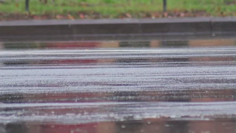 Splashes from car wheels on the road while driving through puddles in the city Stock Footage 314426306