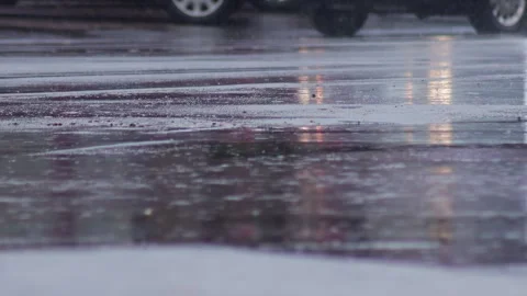 Splashes from car wheels on the road while driving through puddles in the city Stockbeeldmateriaal 315280551