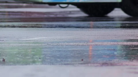 Splashes from car wheels on the road while driving through puddles in the city Stock Footage 315280726
