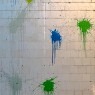 The splashes of color on the wall made of concrete paving stones Stock Photos