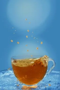 Splashes fly in different directions, iced tea in a Cup 写真素材