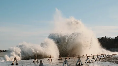 Splashes large strong waves crashing against bright blue sky Stock Footage 129437730