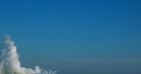 Splashes large strong waves on pier against of bright blue sky spring sunny day Stock Footage 126322186