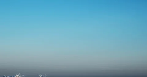 Splashes large strong waves on pier against of bright blue sky spring sunny day Stock Footage 126322298