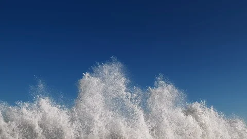 Splashes large strong waves on pier against background of bright blue sky Stock Footage 129437462