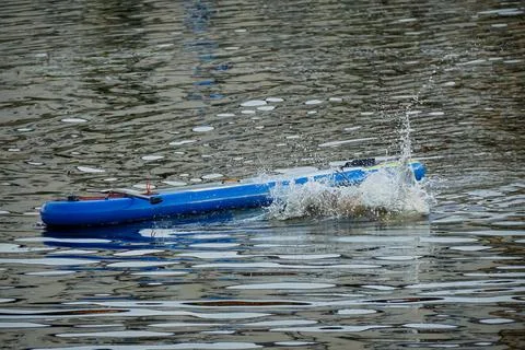 Splashes from a man diving into the water from a sup Stock Photos