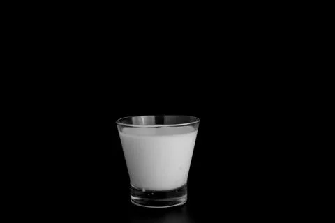 Splashes of milk on a black background Stock Photos