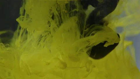 Splashes of multi-colored paints in a glass of water, Stock Footage 215913609