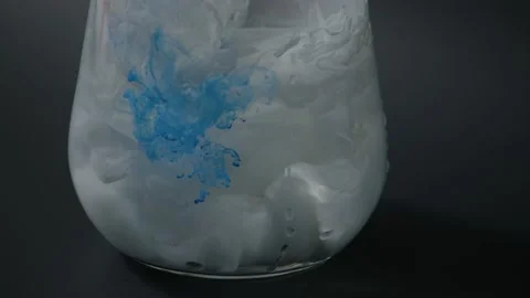 Splashes of multi-colored paints in a glass of water, Stock Footage 215917252