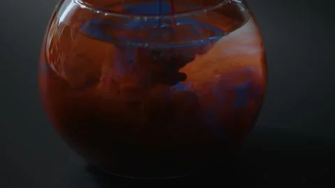 Splashes of multi-colored paints in a glass of water, Stock Footage 215917269