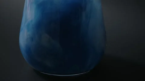 Splashes of multi-colored paints in a glass of water, Stock Footage 215917862