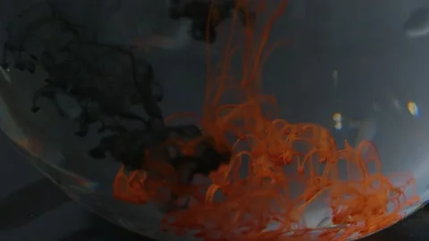 Splashes of multi-colored paints in a glass of water, Stock Footage 215919248