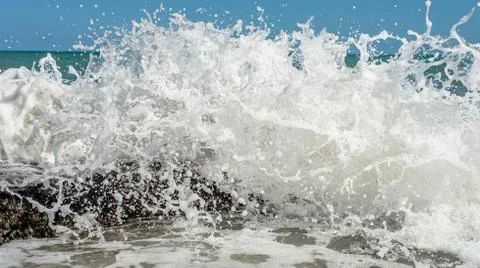 Splashes from ocean waves breaking on the reef, Recife beach, Brazil Stock Photos