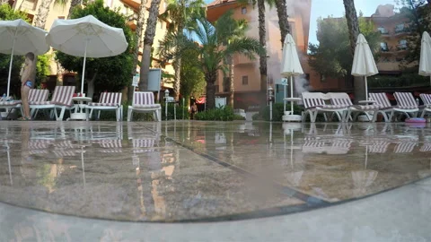 Splashes from the pool water fall and break on the ceramic tiles Stock Footage 128548928