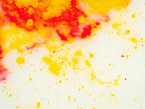Splashes of red and yellow paint, abstract background. Close up shot. Blurred Stock Photos