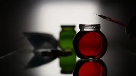 Splashes of red liquid from the syringe Stock Footage 125490646