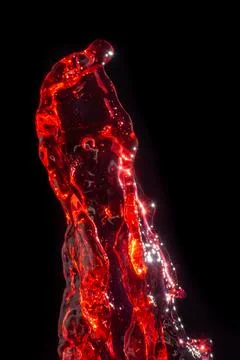 Splashes of red wine on a black background Stock Photos