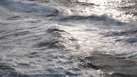 Splashes of sea waves with spray at backlight of sunset Stock Footage 115717014